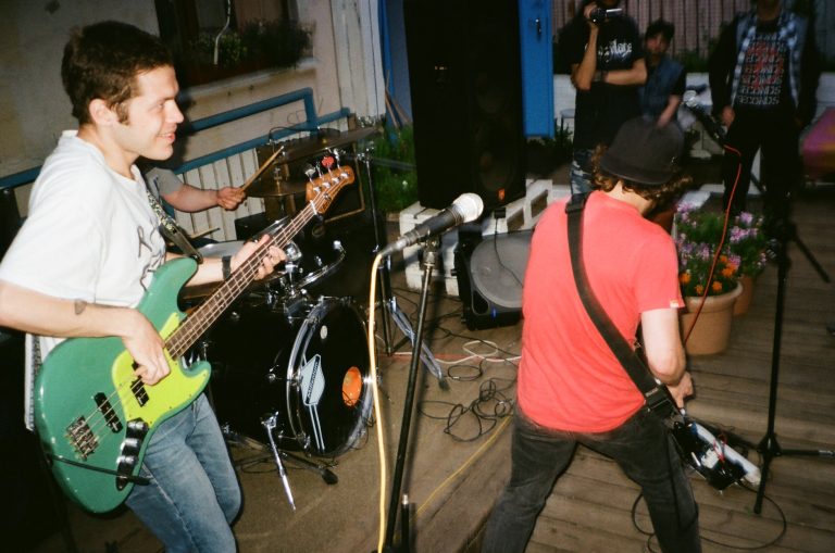 two men playing electric guitars